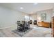Bright living area featuring a dining table, seating, carpet flooring, and neutral wall paint at 10526 Fairhurst Way, Highlands Ranch, CO 80126