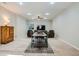 Large living area with a ceiling fan, comfortable seating, a table, and ample lighting at 10526 Fairhurst Way, Highlands Ranch, CO 80126