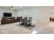 Open living space with a dining table, sofa, and carpet flooring, creating a cozy atmosphere at 10526 Fairhurst Way, Highlands Ranch, CO 80126