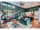 Cozy living room featuring high ceilings, a stone fireplace and an open-concept floorplan at 10526 Fairhurst Way, Highlands Ranch, CO 80126