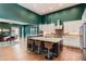 Open layout featuring a kitchen with an island with seating and a dining area at 10526 Fairhurst Way, Highlands Ranch, CO 80126