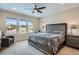 Comfortable main bedroom featuring large windows, a ceiling fan and neutral tones at 10526 Fairhurst Way, Highlands Ranch, CO 80126