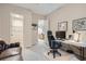 Well-lit home office with comfortable seating and modern computer setup, offering a productive workspace at 10526 Fairhurst Way, Highlands Ranch, CO 80126