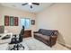 Comfortable office space featuring a leather sofa, desk area, and sports-themed wall decor at 10526 Fairhurst Way, Highlands Ranch, CO 80126