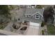 Aerial view of a gray two-story house with a well-manicured lawn, mature trees, and a two-car garage at 5310 S Flanders Way, Centennial, CO 80015