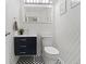 Stylish powder room with geometric floor tiles and modern fixtures at 5310 S Flanders Way, Centennial, CO 80015