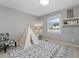 Charming bedroom featuring patterned rug, playful teepee, and cozy chair at 5310 S Flanders Way, Centennial, CO 80015