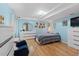 Bright bedroom with hardwood floors, light blue walls, lots of dresser space, and decor at 5310 S Flanders Way, Centennial, CO 80015