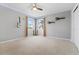 Neutral bedroom with a ceiling fan and two windows at 5310 S Flanders Way, Centennial, CO 80015