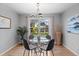 Bright dining room with a glass table set and natural light from the window with neighborhood view at 5310 S Flanders Way, Centennial, CO 80015