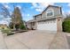 Charming two-story house with a well-maintained lawn, mature trees, and a spacious two-car garage at 5310 S Flanders Way, Centennial, CO 80015