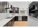 Modern kitchen with dark cabinets, stainless steel appliances, and a sleek countertop at 5310 S Flanders Way, Centennial, CO 80015