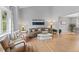 Open living room featuring hardwood floors, neutral-toned furniture, and ample natural light through large windows at 5310 S Flanders Way, Centennial, CO 80015