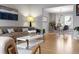 Bright and airy open floor plan with hardwood floors, a tan couch, and modern decor at 5310 S Flanders Way, Centennial, CO 80015