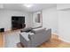Modern living room with hardwood floors, a comfortable couch, and a large television, perfect for entertaining at 5310 S Flanders Way, Centennial, CO 80015