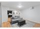 Cozy living room with a gray couch, ottoman, and decorative rug at 5310 S Flanders Way, Centennial, CO 80015