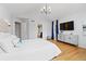 Comfortable main bedroom features hardwood floors, vaulted ceiling, and view to bathroom at 5310 S Flanders Way, Centennial, CO 80015