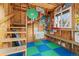 Playhouse interior features a ladder, ample shelving, and a window, perfect for creative play and storage at 5310 S Flanders Way, Centennial, CO 80015