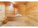 Inviting sauna with wooden benches, paneling, a bucket, and a ladle for an authentic spa experience at 5310 S Flanders Way, Centennial, CO 80015