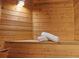 Inviting sauna with wooden benches, paneling, a bucket, and a ladle for an authentic spa experience at 5310 S Flanders Way, Centennial, CO 80015