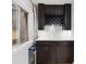 Charming wine cellar area featuring custom cabinets, wine glass racks, a wine cooler, and ample storage at 5310 S Flanders Way, Centennial, CO 80015