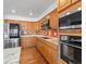 Close-up shot of kitchen featuring stainless appliances, granite countertops, and ample cabinetry at 12899 W Aqueduct Ave, Littleton, CO 80127