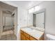 Bathroom with vanity and mirror, tile flooring, and entry to mirrored closet at 2225 Buchtel Blvd # 208, Denver, CO 80210