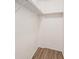 This walk-in closet has white walls, wood-look floors, and wire racks for maximum storage efficiency at 2225 Buchtel Blvd # 208, Denver, CO 80210