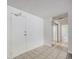 Hallway with ceramic tile, white walls, closet with mirrored doors and entry to bathroom at 2225 Buchtel Blvd # 208, Denver, CO 80210