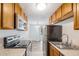 Bright kitchen featuring wooden cabinets, modern appliances, and a view to a patio at 2225 Buchtel Blvd # 208, Denver, CO 80210
