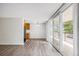 Living room adjacent to the kitchen with luxury vinyl plank floors, a sliding glass door, and lots of light at 2225 Buchtel Blvd # 208, Denver, CO 80210