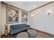 Decorated lobby with two framed vintage poster prints, comfortable sitting and stone tiled flooring at 2225 Buchtel Blvd # 208, Denver, CO 80210
