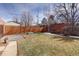 Fenced-in backyard featuring grass, a gravel area, and a wooden fence at 1280 Fairfax St, Denver, CO 80220