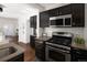 Beautiful kitchen with stainless steel appliances, dark cabinets, light countertops and open view of the living spaces at 1280 Fairfax St, Denver, CO 80220