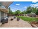 Enjoy outdoor living with a large brick patio featuring comfortable seating and well-maintained lawn at 5490 E Kentucky Ave, Denver, CO 80246