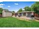 Relax in the large backyard with brick patio, outdoor seating, and a convenient storage shed at 5490 E Kentucky Ave, Denver, CO 80246