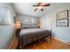 This tranquil bedroom features hardwood floors, a wrought iron bed, and natural light from two windows at 5490 E Kentucky Ave, Denver, CO 80246