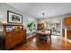 Bright dining room with a decorative chandelier, hardwood floors, and sliding glass doors at 5490 E Kentucky Ave, Denver, CO 80246