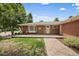 Attractive brick home featuring a welcoming front patio and manicured front lawn at 5490 E Kentucky Ave, Denver, CO 80246