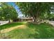 Charming home with a well-maintained front yard, mature tree, and attractive landscaping at 5490 E Kentucky Ave, Denver, CO 80246