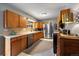 Well-lit kitchen features stainless steel appliances, oak cabinets and a modern patterned rug at 5490 E Kentucky Ave, Denver, CO 80246