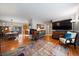 Spacious living room with hardwood floors, a colorful rug, and ample natural light at 5490 E Kentucky Ave, Denver, CO 80246