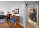 Open-concept living area leading to the kitchen, featuring hardwood floors and modern decor at 5490 E Kentucky Ave, Denver, CO 80246