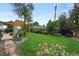 Well-maintained backyard with patio and lush lawn, enhanced by mature landscaping and garden features at 2925 S Harrison St, Denver, CO 80210