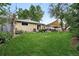 Expansive backyard with lush green lawn, garden beds and patio area offering serene outdoor living at 2925 S Harrison St, Denver, CO 80210
