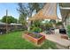 Beautiful backyard featuring a shade sail, dining area, and garden at 2925 S Harrison St, Denver, CO 80210