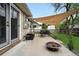 Backyard patio with a fire pit, shade sail, and dining set at 2925 S Harrison St, Denver, CO 80210