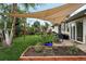 Charming backyard with a shade sail over a dining area and a raised garden bed at 2925 S Harrison St, Denver, CO 80210