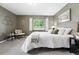 Comfortable bedroom with neutral carpet and olive green walls, featuring windows with natural light and a queen bed at 2925 S Harrison St, Denver, CO 80210