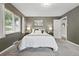 Bright bedroom with gray walls, carpeted floors, and a comfortable bed at 2925 S Harrison St, Denver, CO 80210